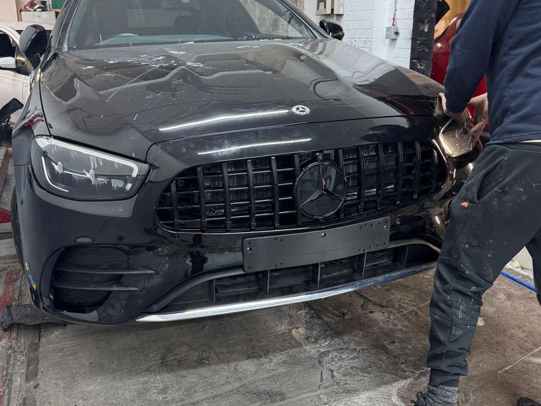 Black Mercedes-AMG with the front end stripped down inside the N17 Bodyworks workshop