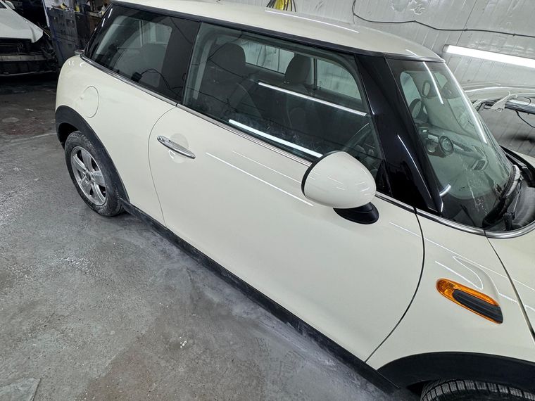 The same MINI Cooper with the door and rear quarter repaired and resprayed in the original white